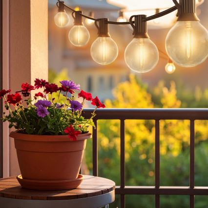 Brilagi - Guirlanda decorativa LED para exterior 25xE12/0,6W/230V 20m preta IP44 branco quente + comando à distância