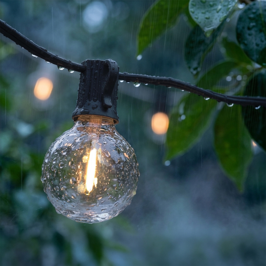 Brilagi - Guirlanda decorativa LED para exterior 25xE12/0,6W/230V 20m preta IP44 branco quente + comando à distância