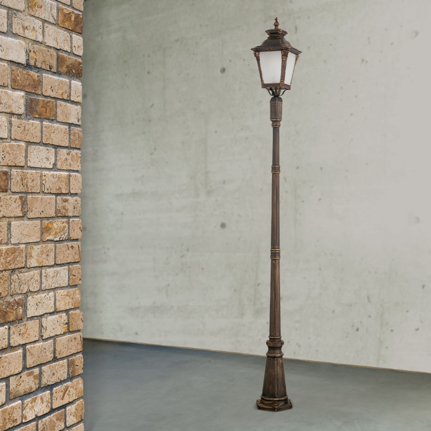Candeeiro de exterior AIKO 1xE27/60W/230V 240 cm IP23 bronze/patina